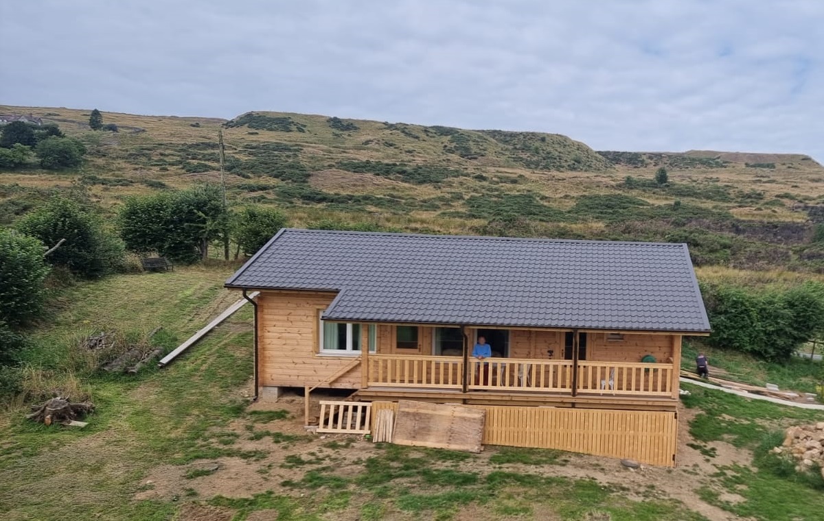 Photo of the log cabin annexe nearly complete taken from a drone